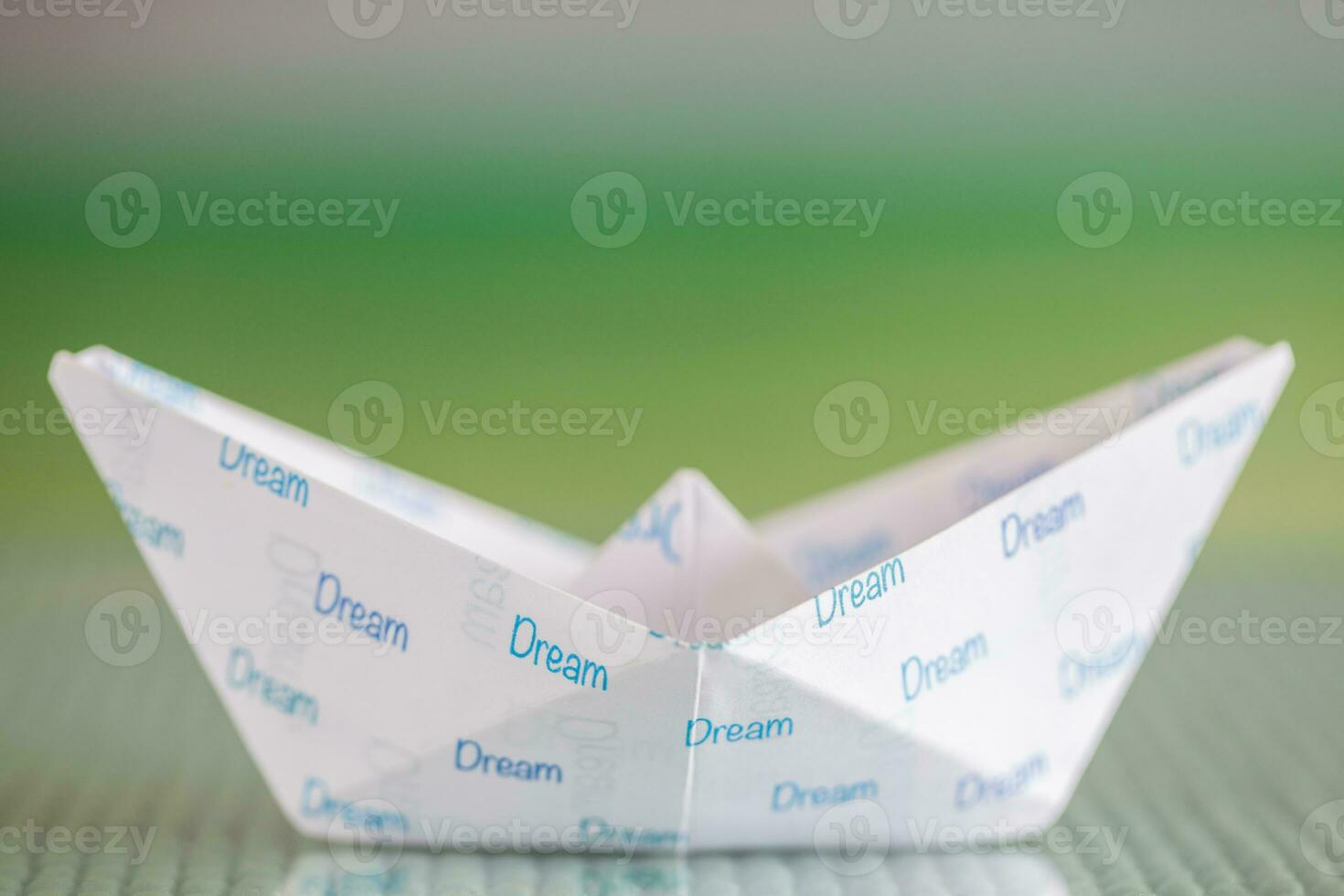 Follow your dreams concept. Origami boat photo