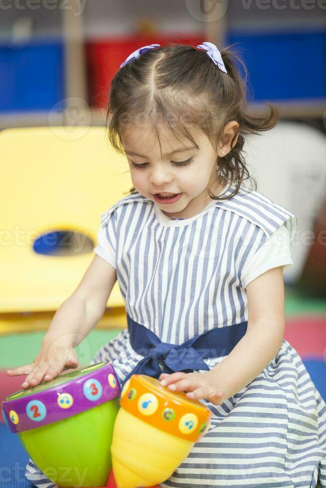 Sweet little girl learning to play instruments. photo