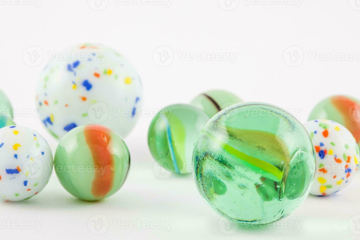 Glass marble balls isolated on white background photo