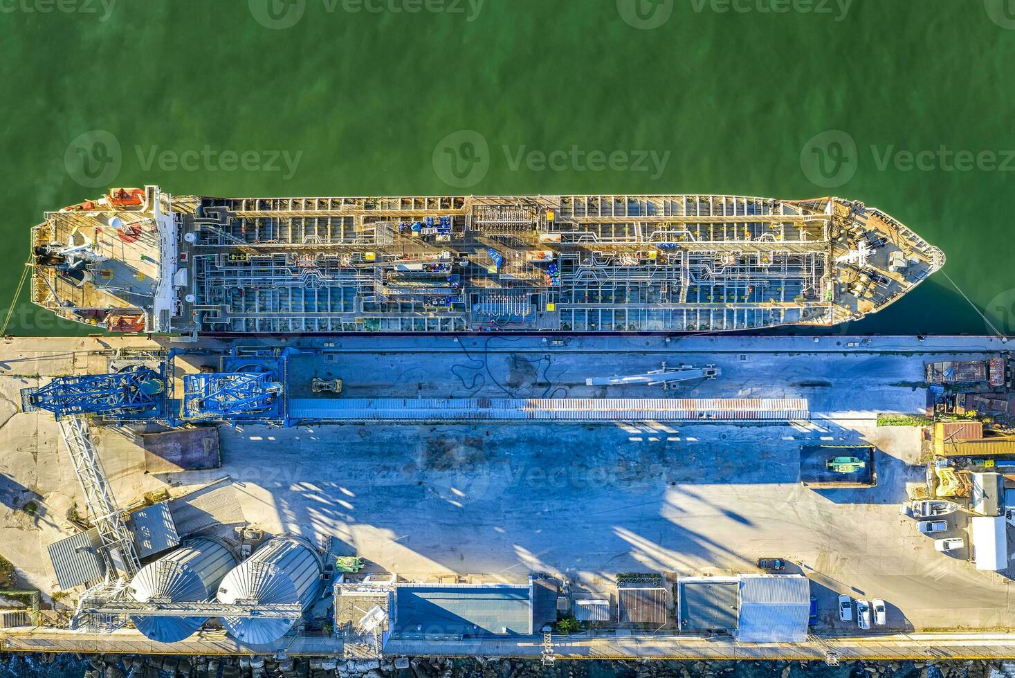 A chemical tanker of the city port. Aerial top view from a drone. Concept export ship photo