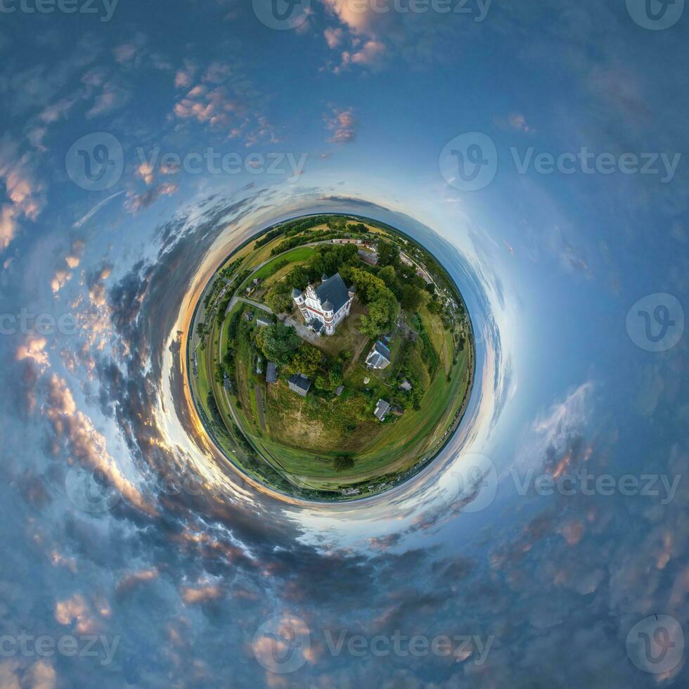 little planet transformation of spherical panorama 360 degrees overlooking church in center of globe in blue sky. Spherical abstract aerial view with curvature of space. photo