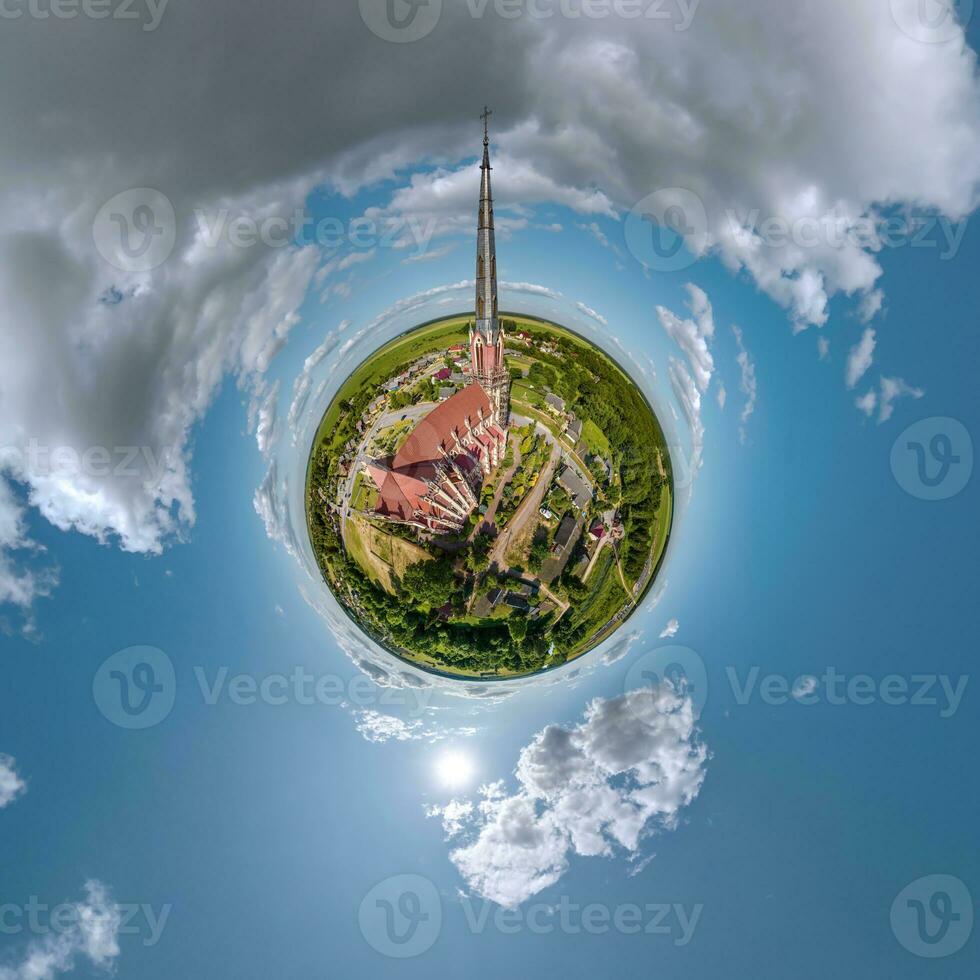 little planet transformation of spherical panorama 360 degrees overlooking church in center of globe in blue sky. Spherical abstract aerial view with curvature of space. photo