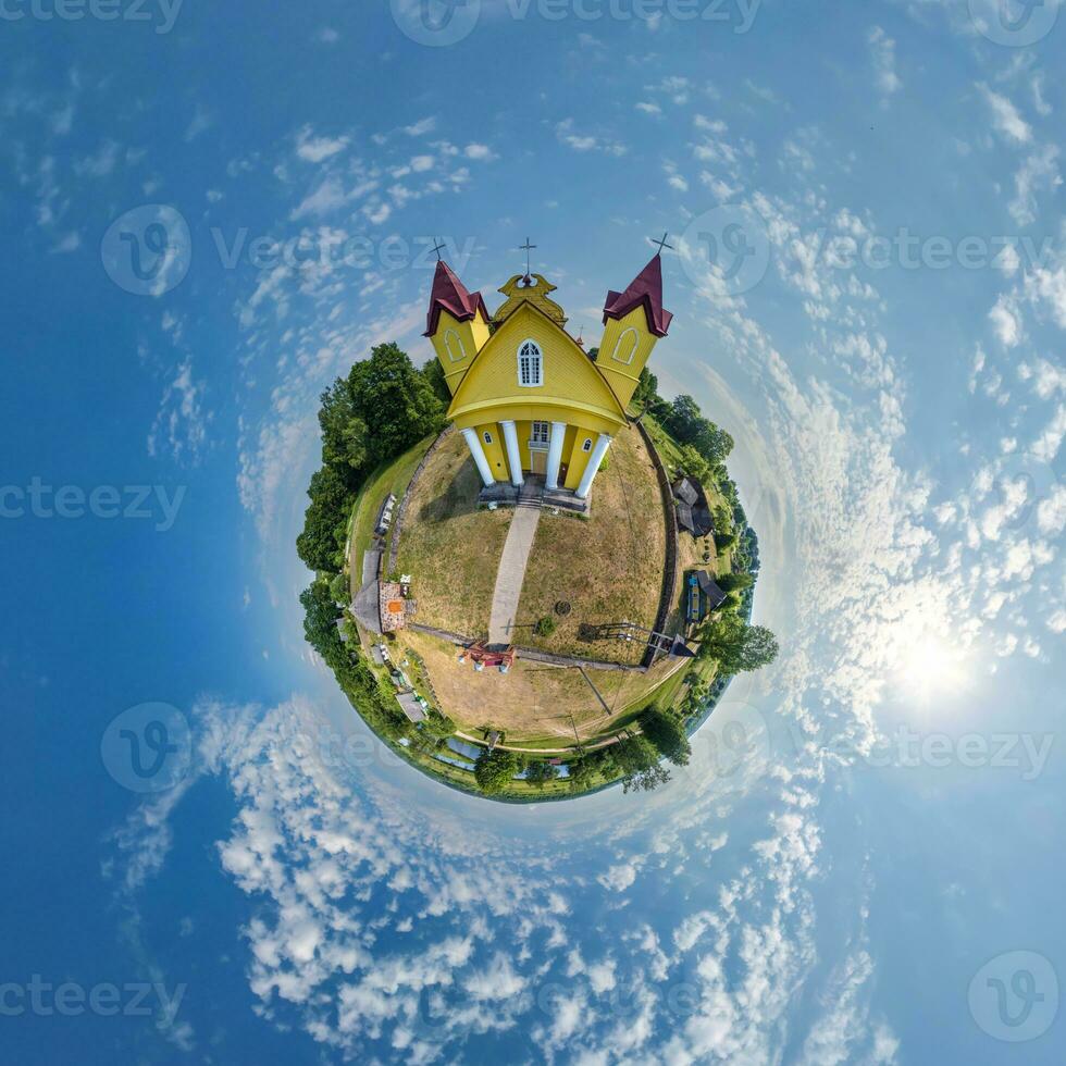 little planet transformation of spherical panorama 360 degrees overlooking church in center of globe in blue sky. Spherical abstract aerial view with curvature of space. photo