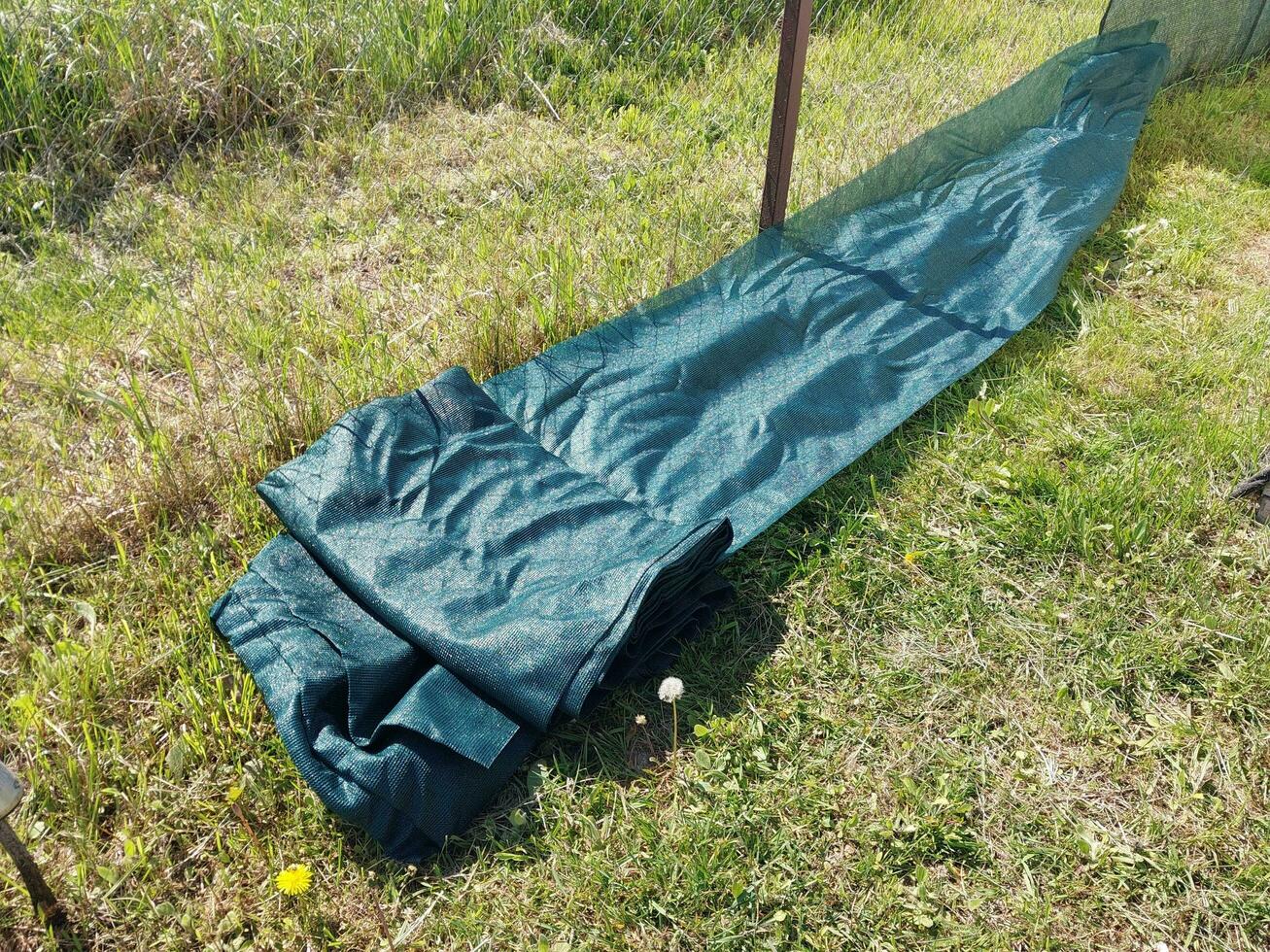 Installation of a protective mesh on the fence photo