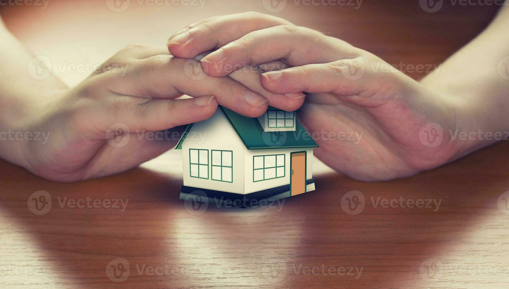 Hands saving small house photo