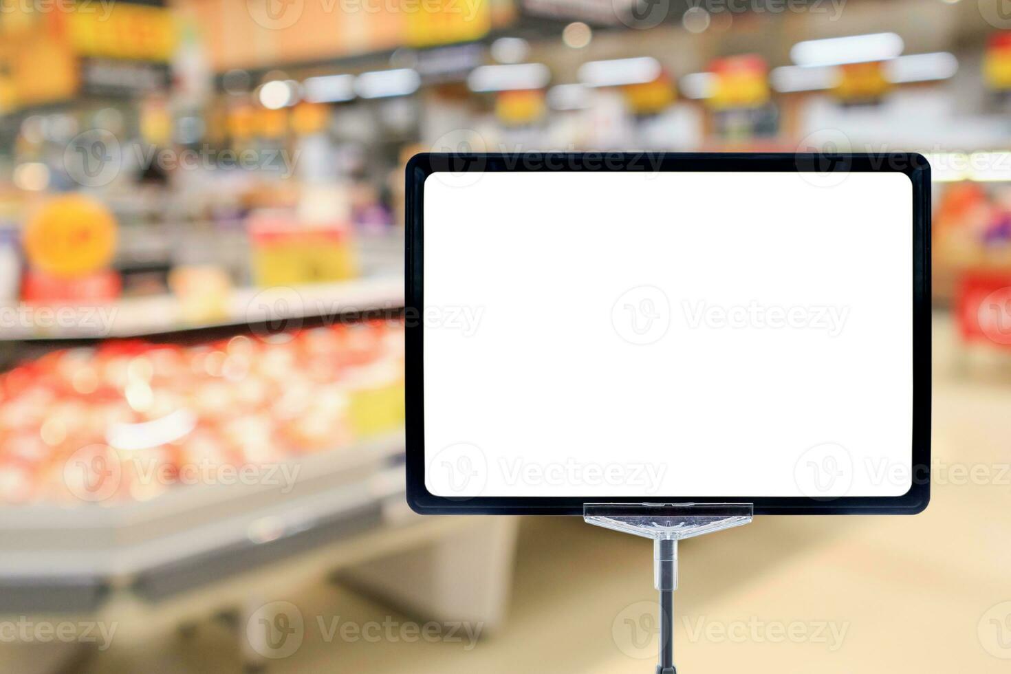 Blank price board with fresh food in supermarket abstract blurred background photo