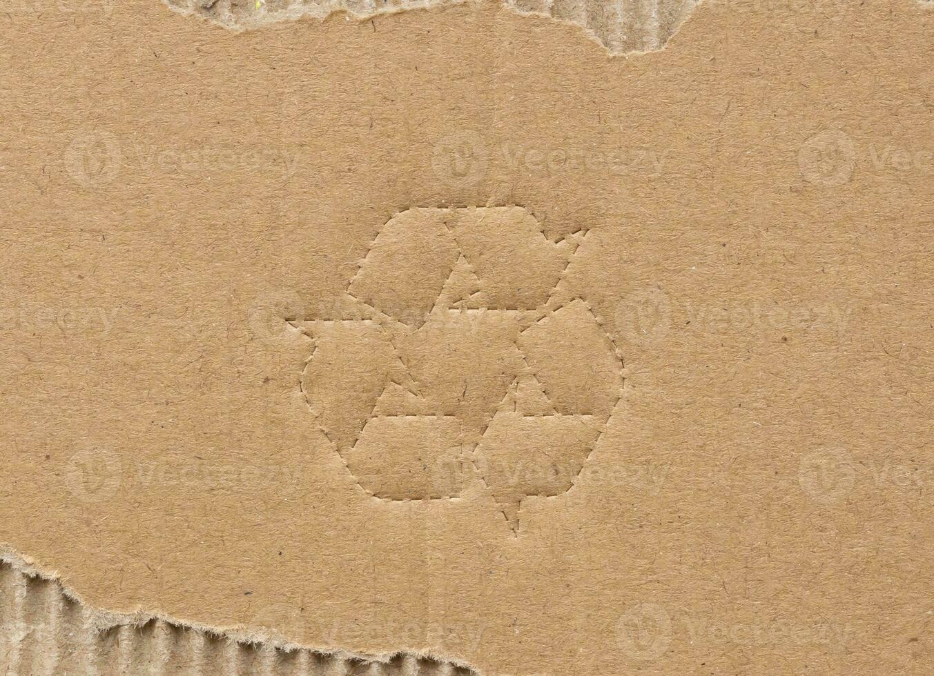 recycle symbol on brown cardboard paper background photo