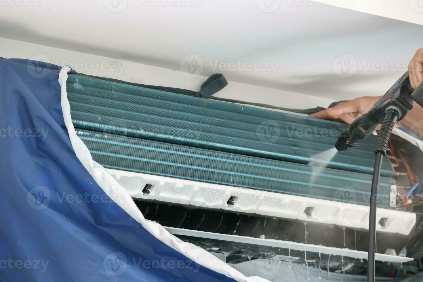 air conditioning cleaning service with water spray photo