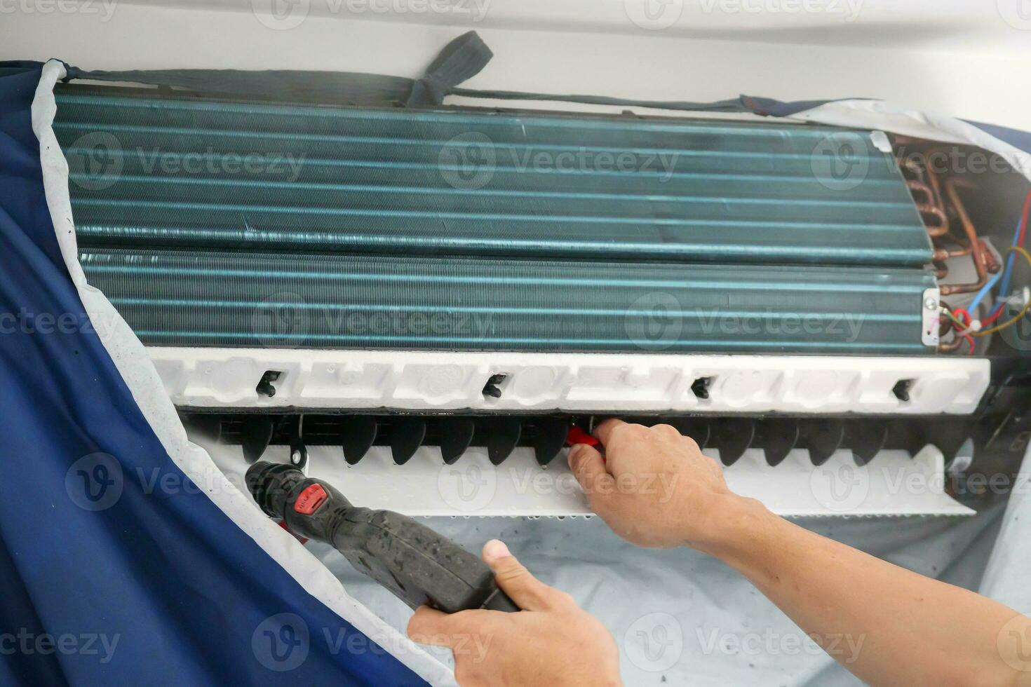 air conditioning cleaning service with water spray photo