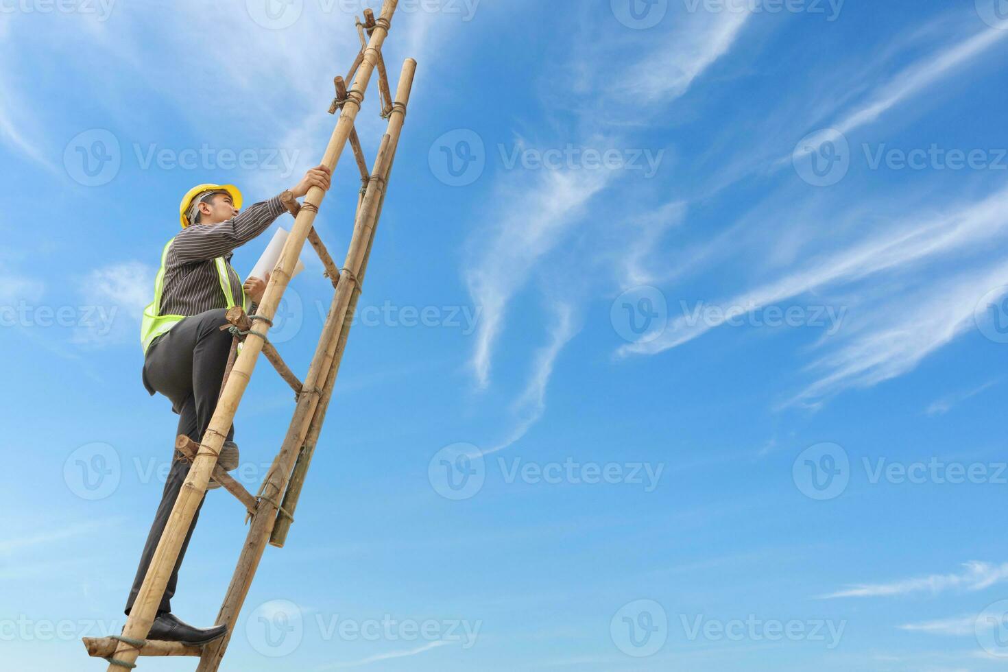 Asian business man engineer climbing up ladder with blue sky, career growth and success concept photo