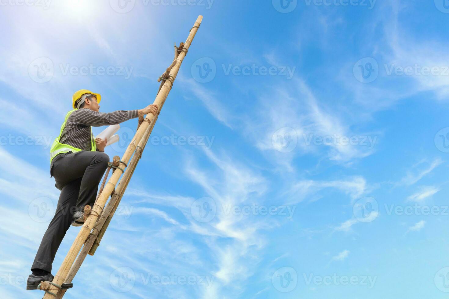 Asian business man engineer climbing up ladder with blue sky, career growth and success concept photo