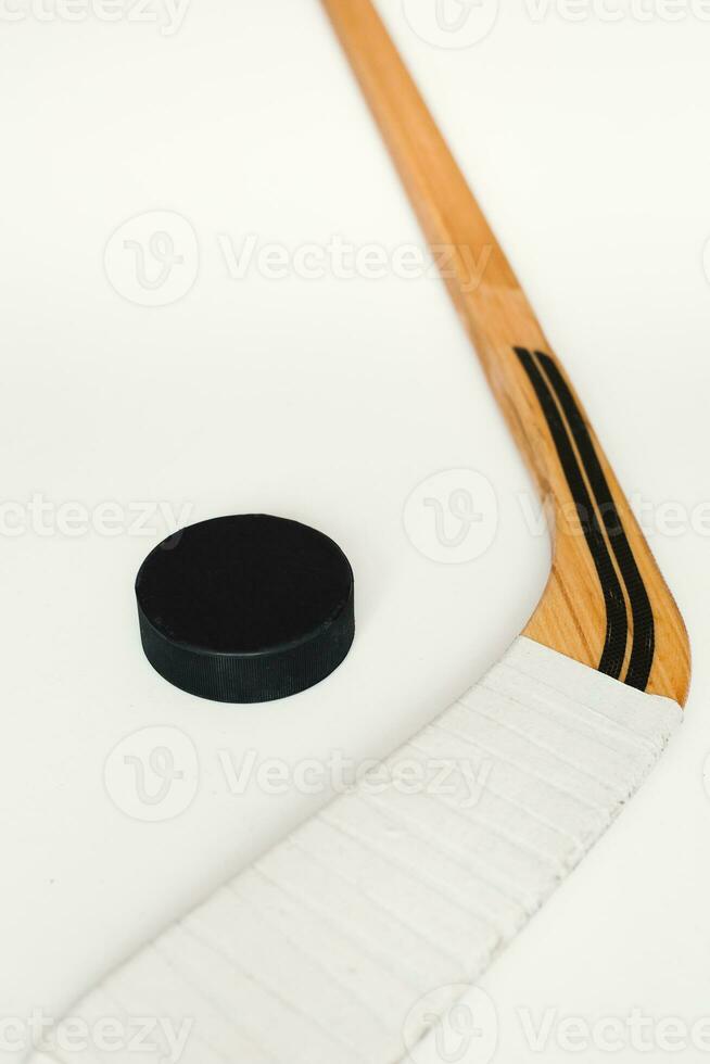 Hockey backdrop with copy space on white background - hockey stick and puck - vertical frame photo