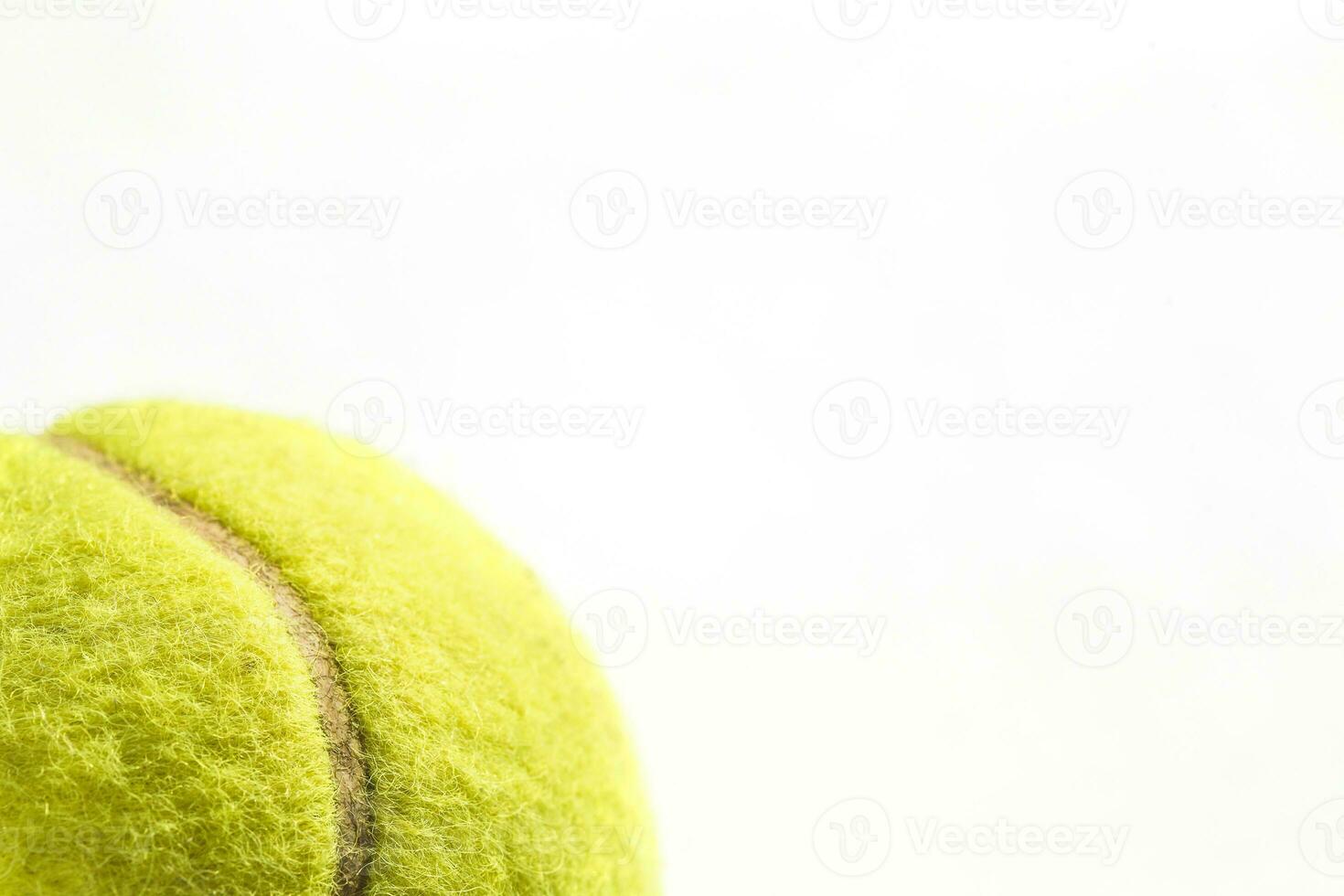 Fragment of yellow tennis ball close up on white isolated background - tennis background photo