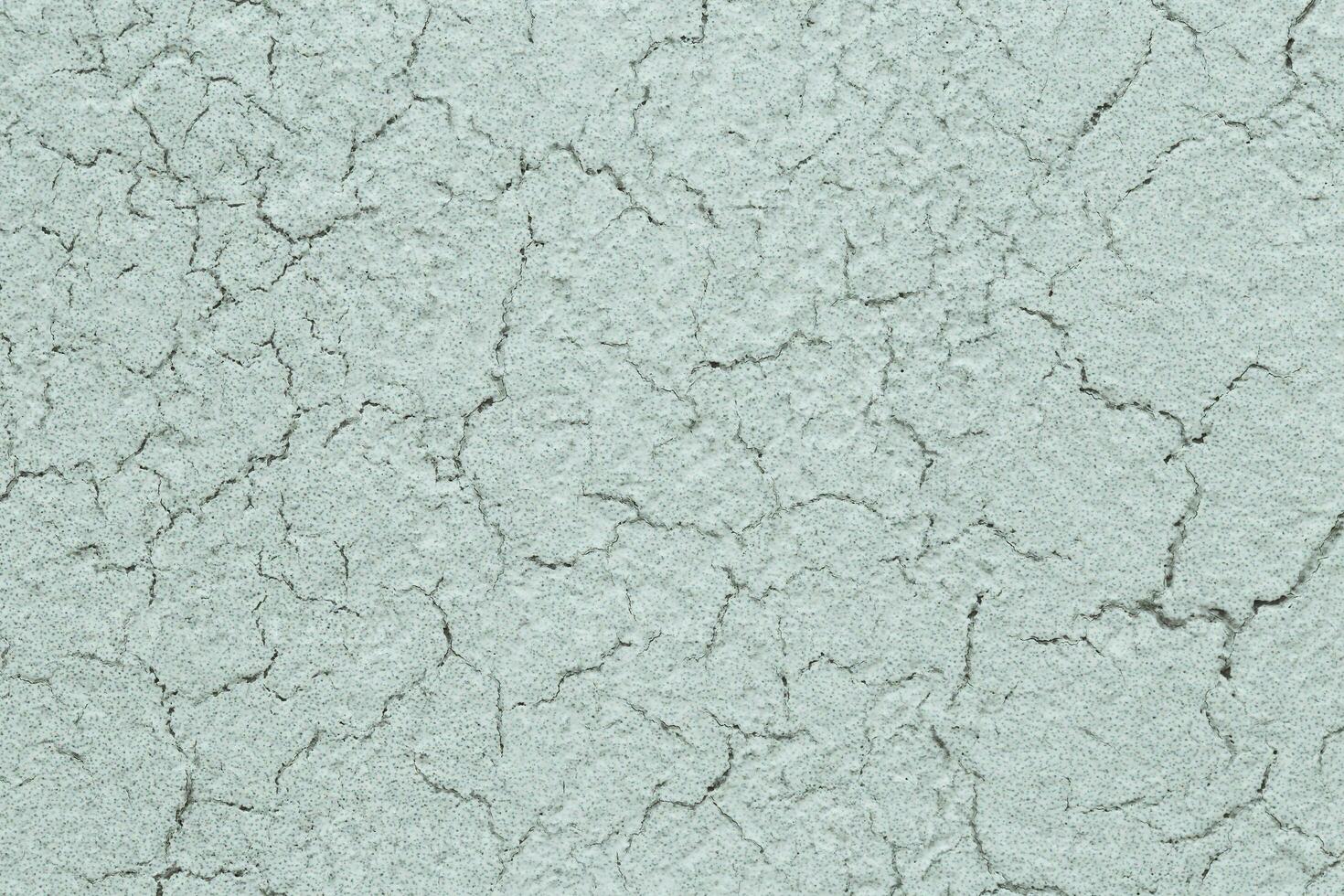 Background with cracks on a light wall - raw plaster or old canvas