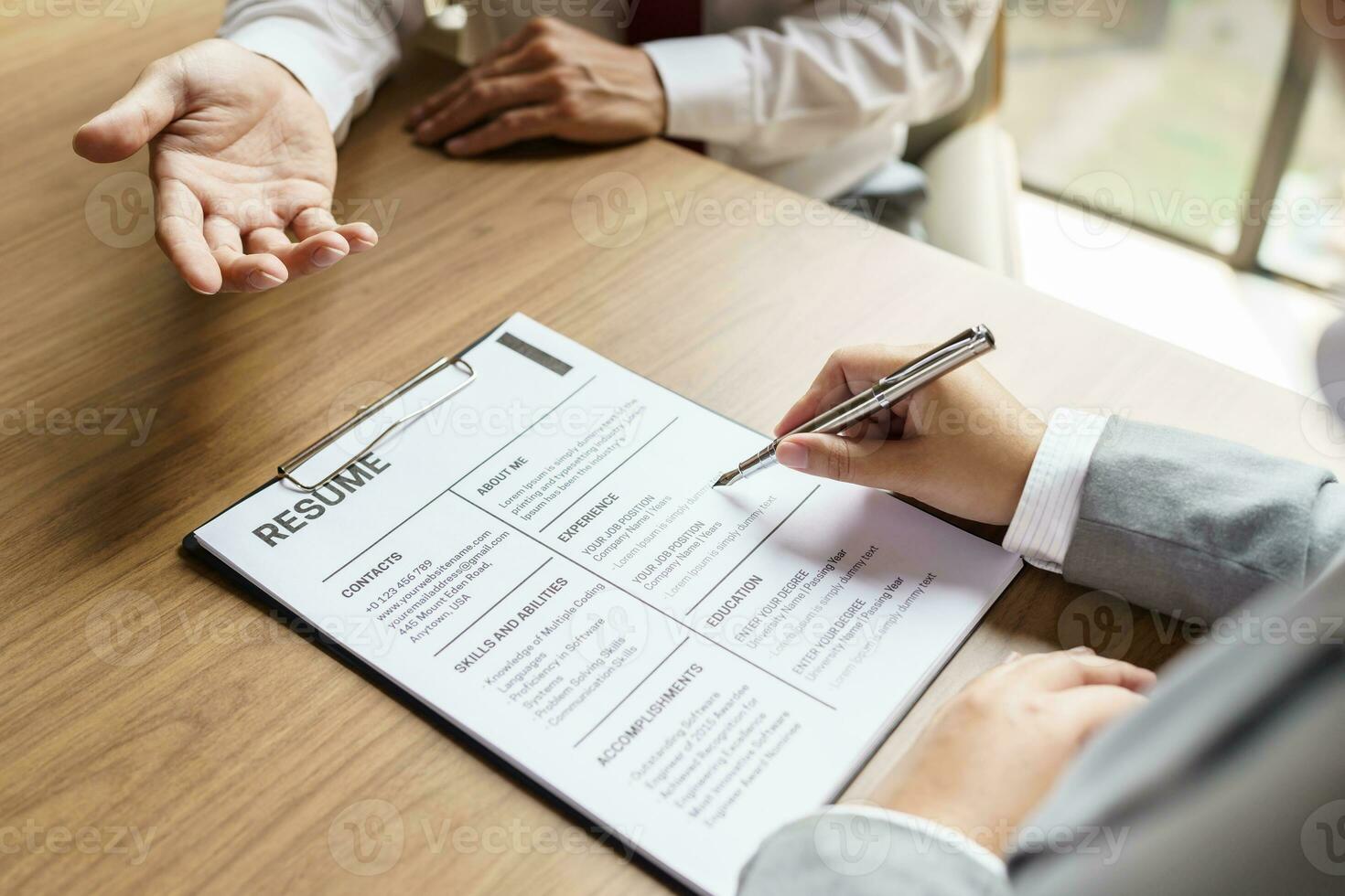 Examiner reading a resume during job interview at office Business and human resources concept photo