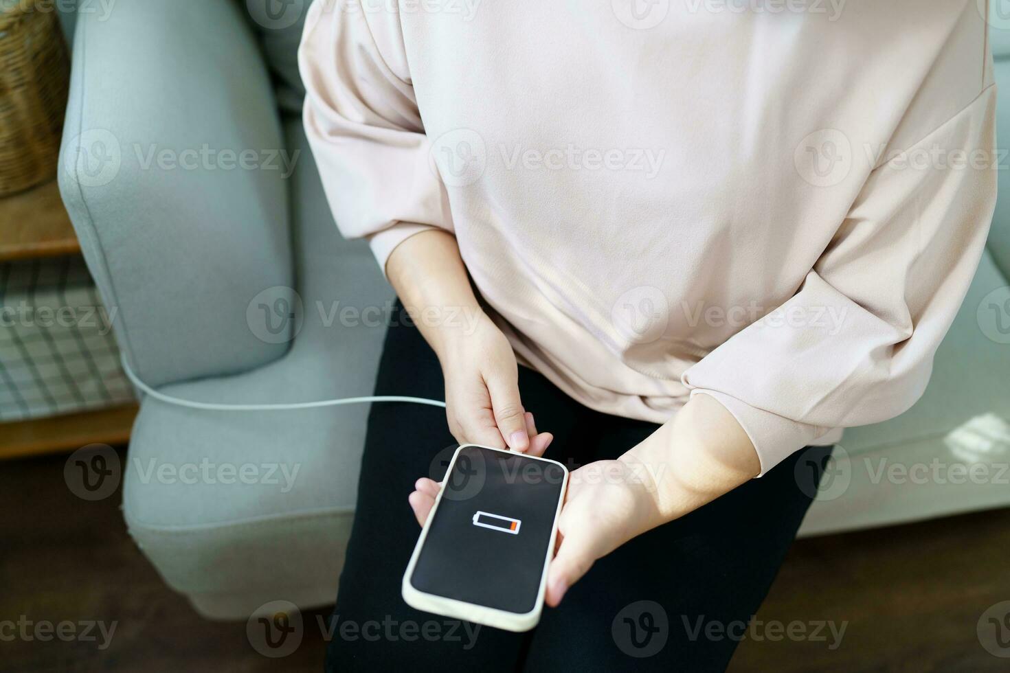 Woman hands Charging mobile phone battery with low battery. plugging a charger in a smart phone  with energy bank powerbank power charger Modern lifestyle energy technology concept photo