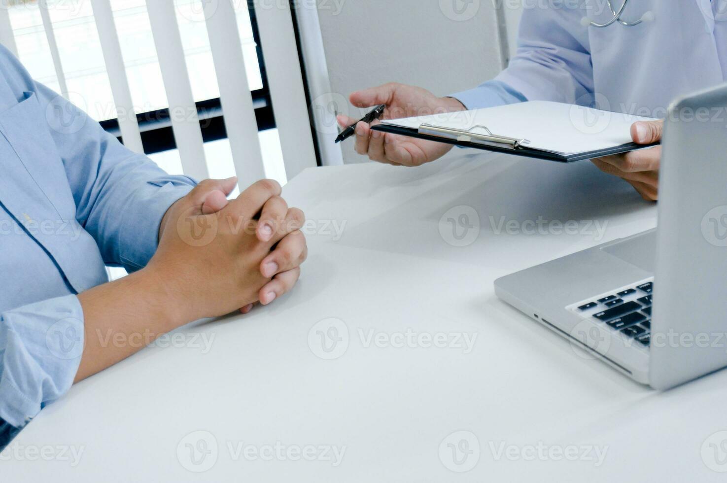 Professional medical doctor in white uniform gown coat interview consulting patient. photo
