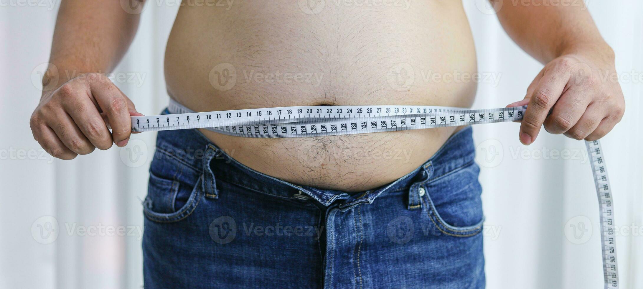 Man with fat belly in dieting concept. Overweight man touching his fat belly and want to lose weight. photo