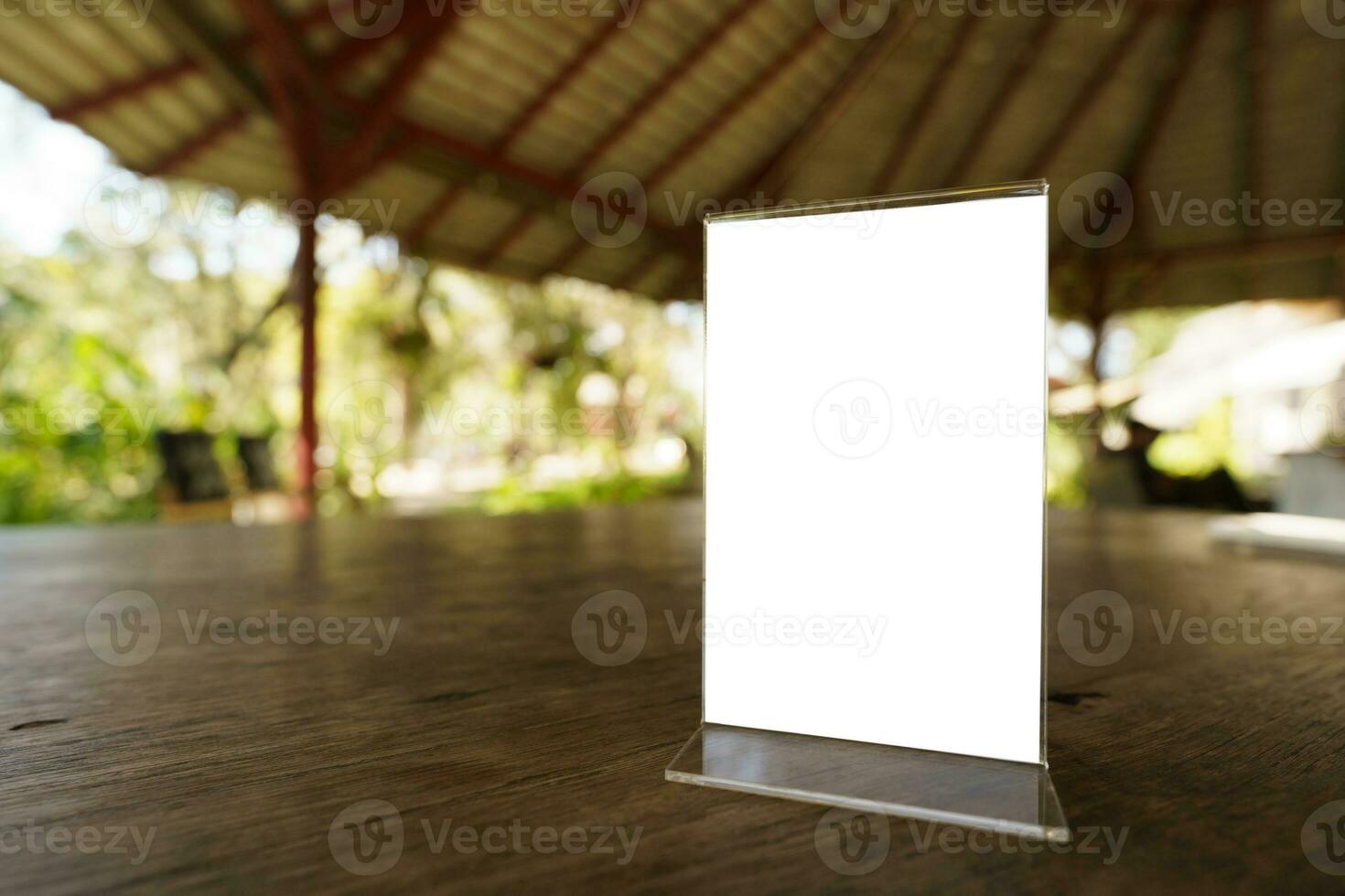 Mock up Menu frame standing on wood table photo