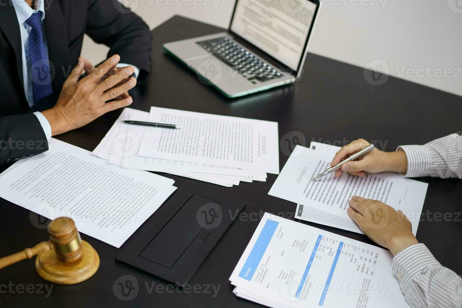 Legal counsel presents to the client a signed contract with gavel and legal law. justice and lawyer concept photo