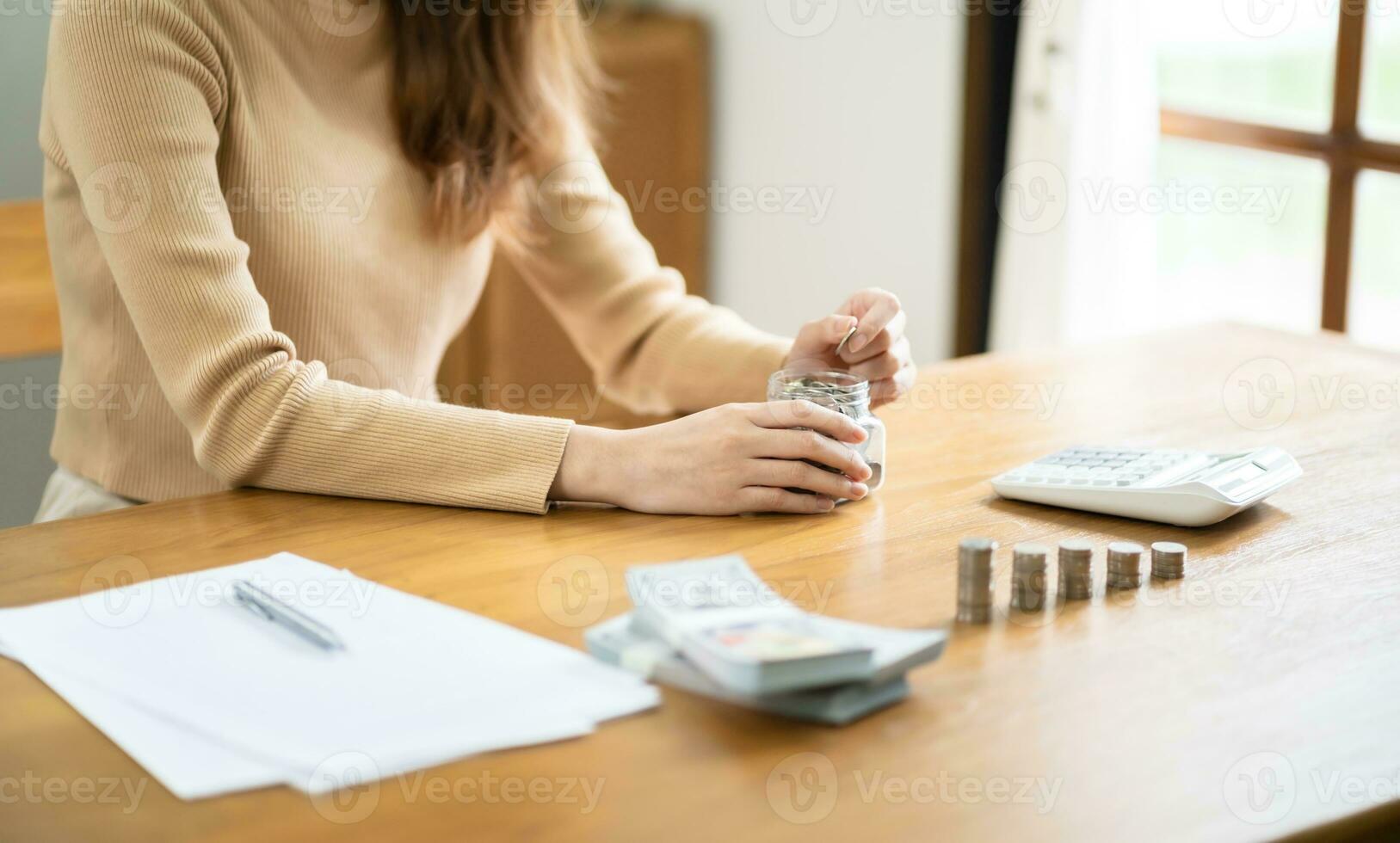 Saving money. Businesswoman Accountant verify growing business and saving money stacking coins with calculator. Accountancy Concept photo
