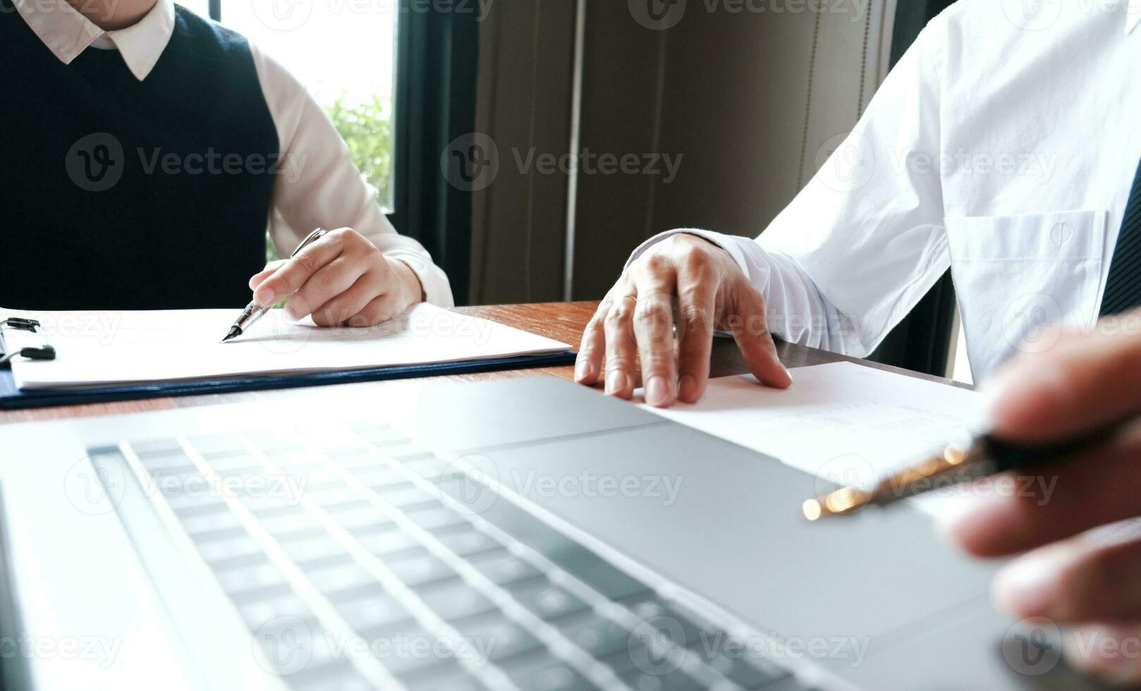 Businessman analyzing investment charts and pressing calculator buttons over documents. Accounting Concept. photo