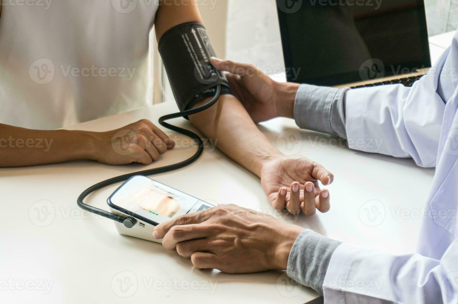 Doctor healthcare. Professional medical doctor in white uniform gown coat interview consulting patient reassuring his male patient helping hand photo