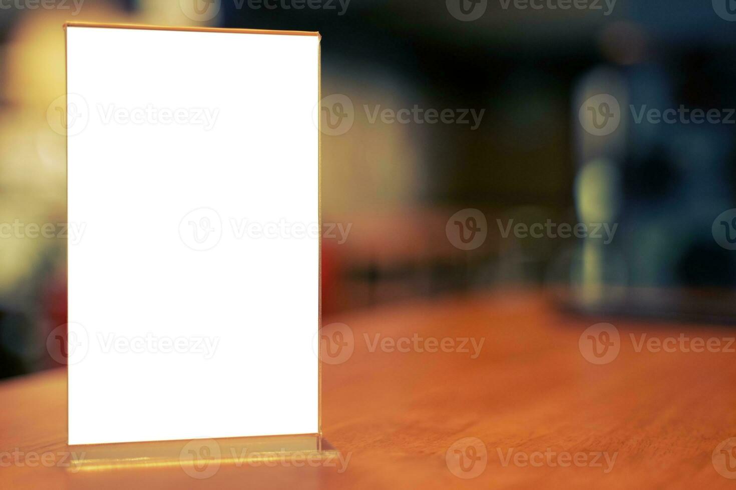 Mock up Menu frame standing on wood table in Bar restaurant cafe. space for text photo