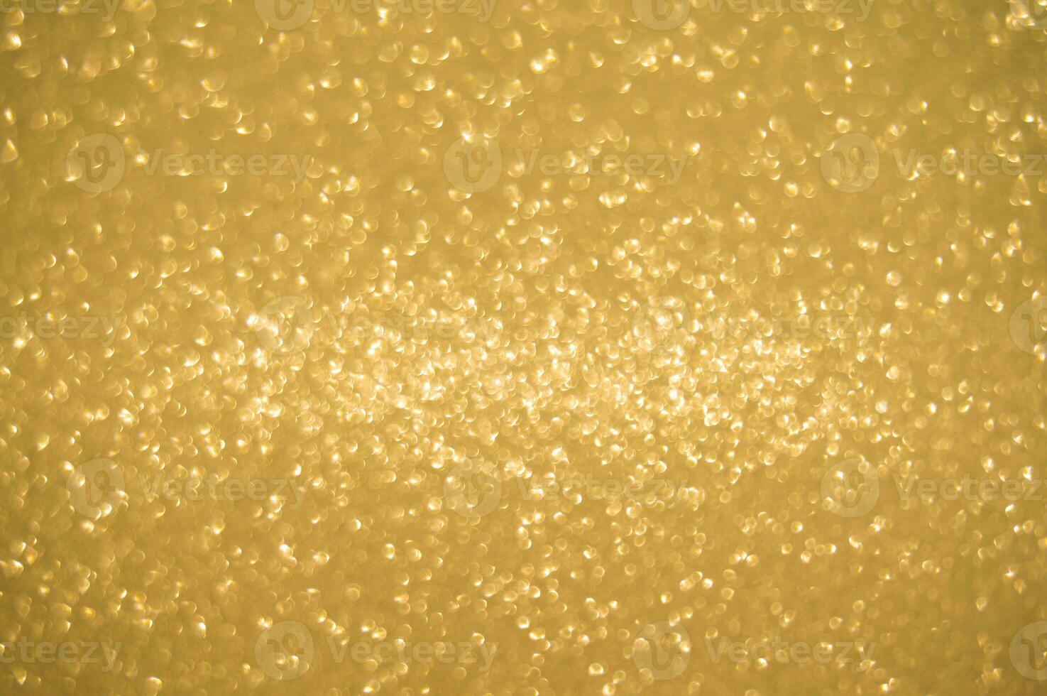 Gold glitters background. shimmering blur spot lights Bokeh Shiny gold light background. photo