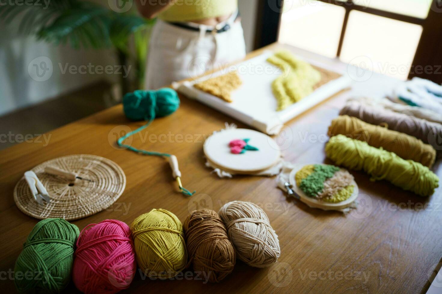 Punch needle. Asian Woman making handmade Hobby knitting in studio workshop. designer workplace Handmade craft project DIY embroidery concept. photo