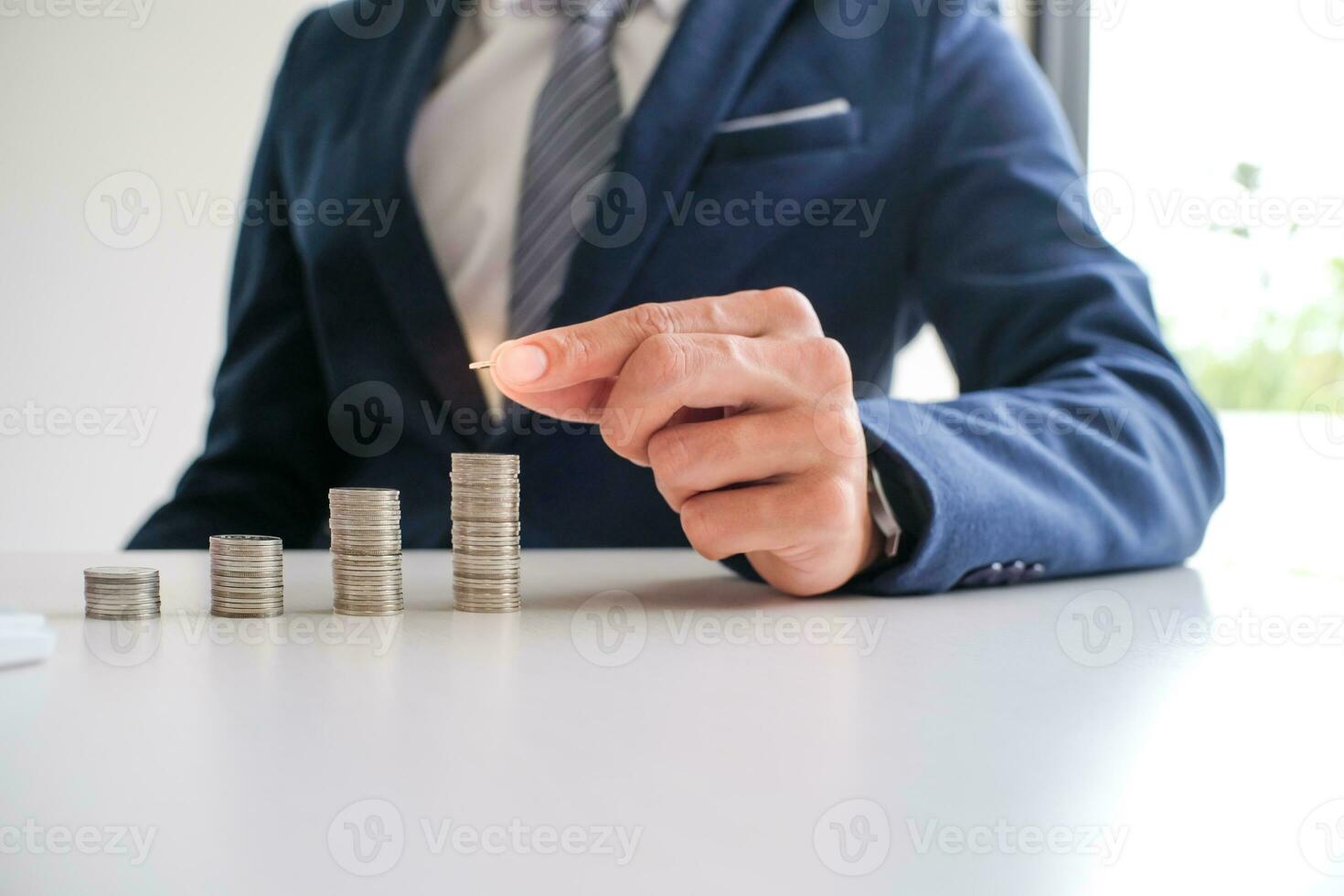 Saving money. Businessman Accountant verify growing business and saving money stacking coins with calculator. Accountancy Concept. photo