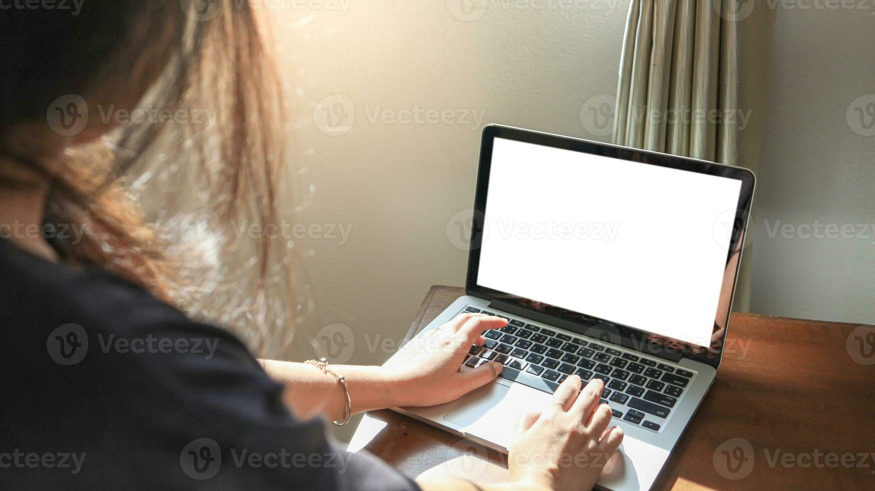 Woman working from home E learning home isolation auto quarantine woman working on laptop computer while sitting at the living room photo