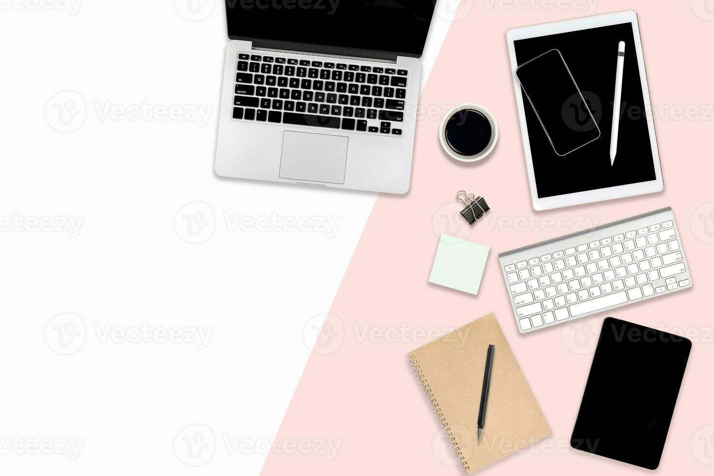 Flat lay photo of Office table with laptop computer, digital tablet, and mobile phone on modern two tone background.
