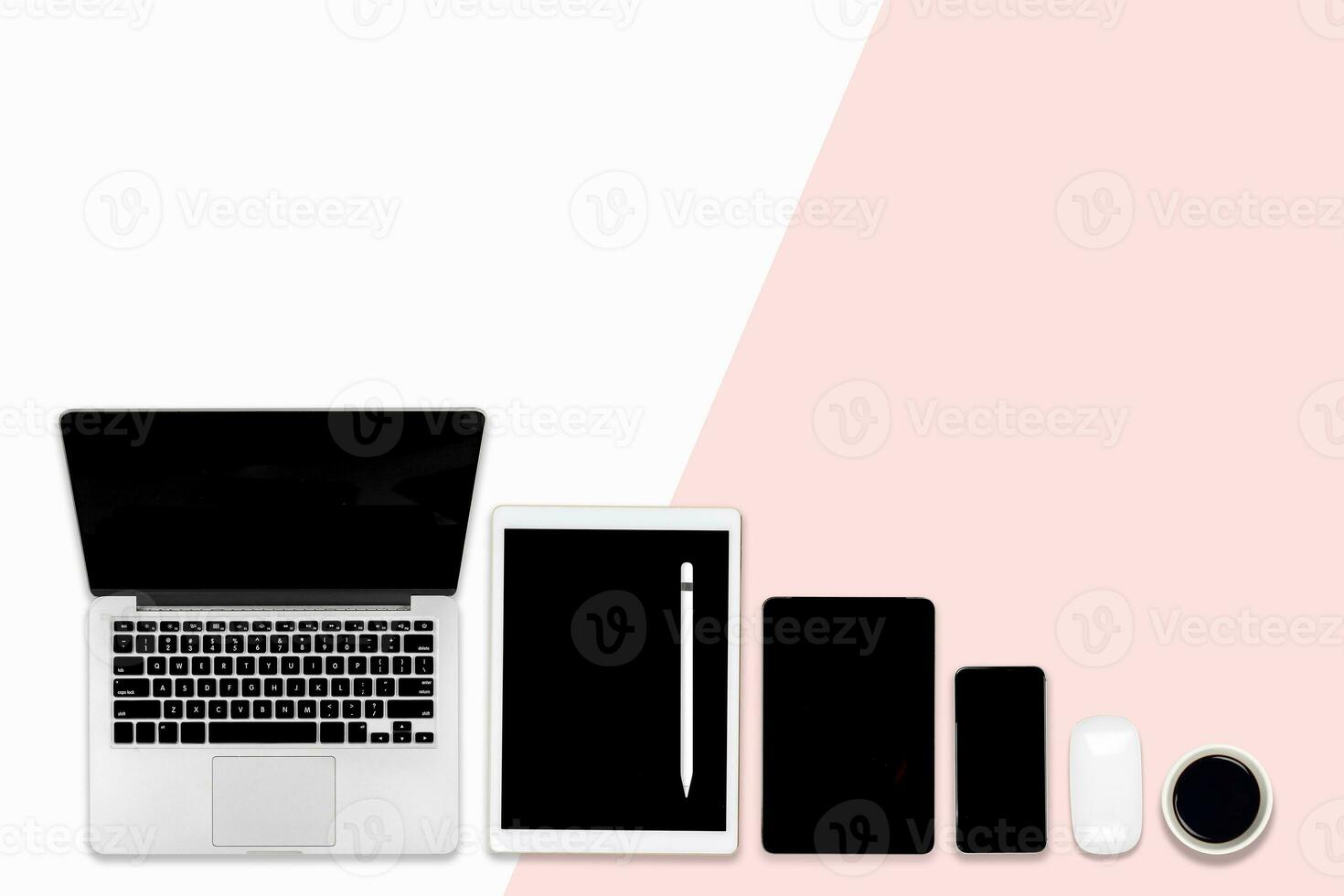 Flat lay photo of Office table with laptop computer, digital tablet, and mobile phone on modern two tone background.