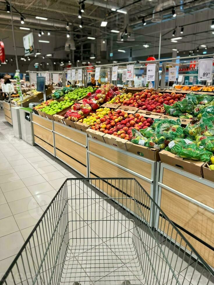 Shopper cart in vegetable department supermarket photo