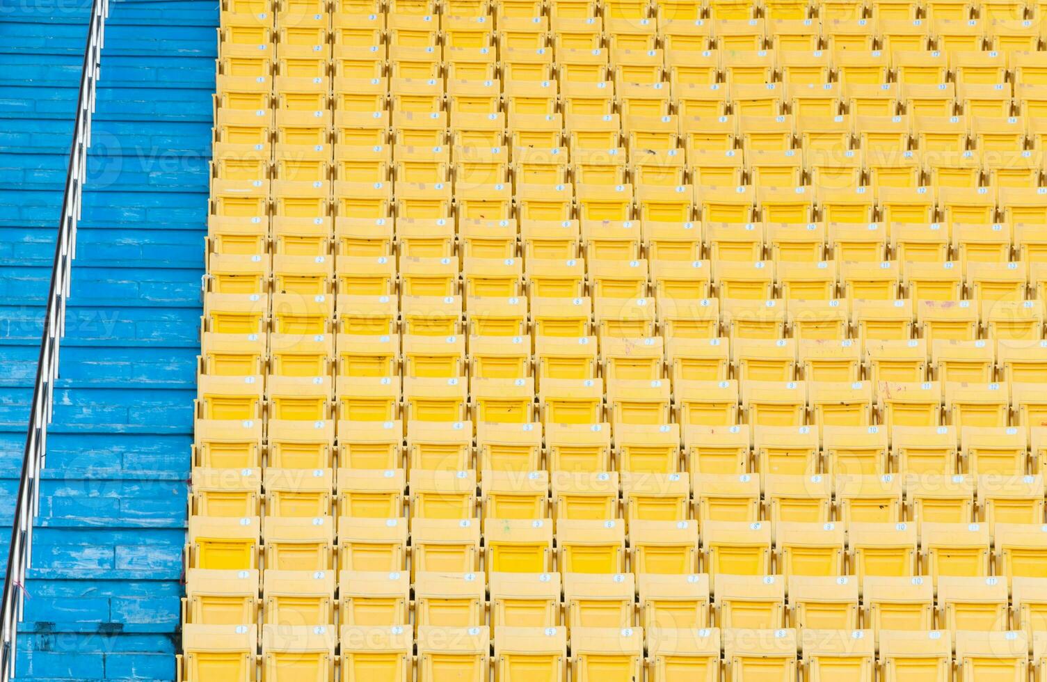 Empty yellow seats at stadium,Rows walkway of seat on a soccer stadium photo