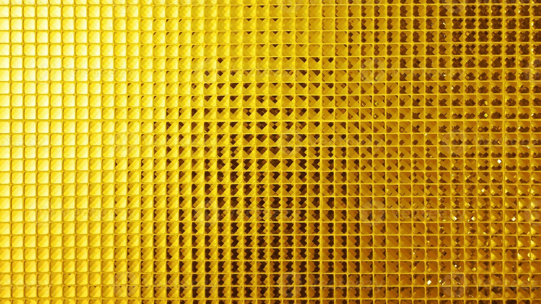 Golden yellow square mosaic for background, Wall is decorated with stained glass small plate, Beautiful mosaic wall luxurious or ceramic wall for luxurious pattern background photo