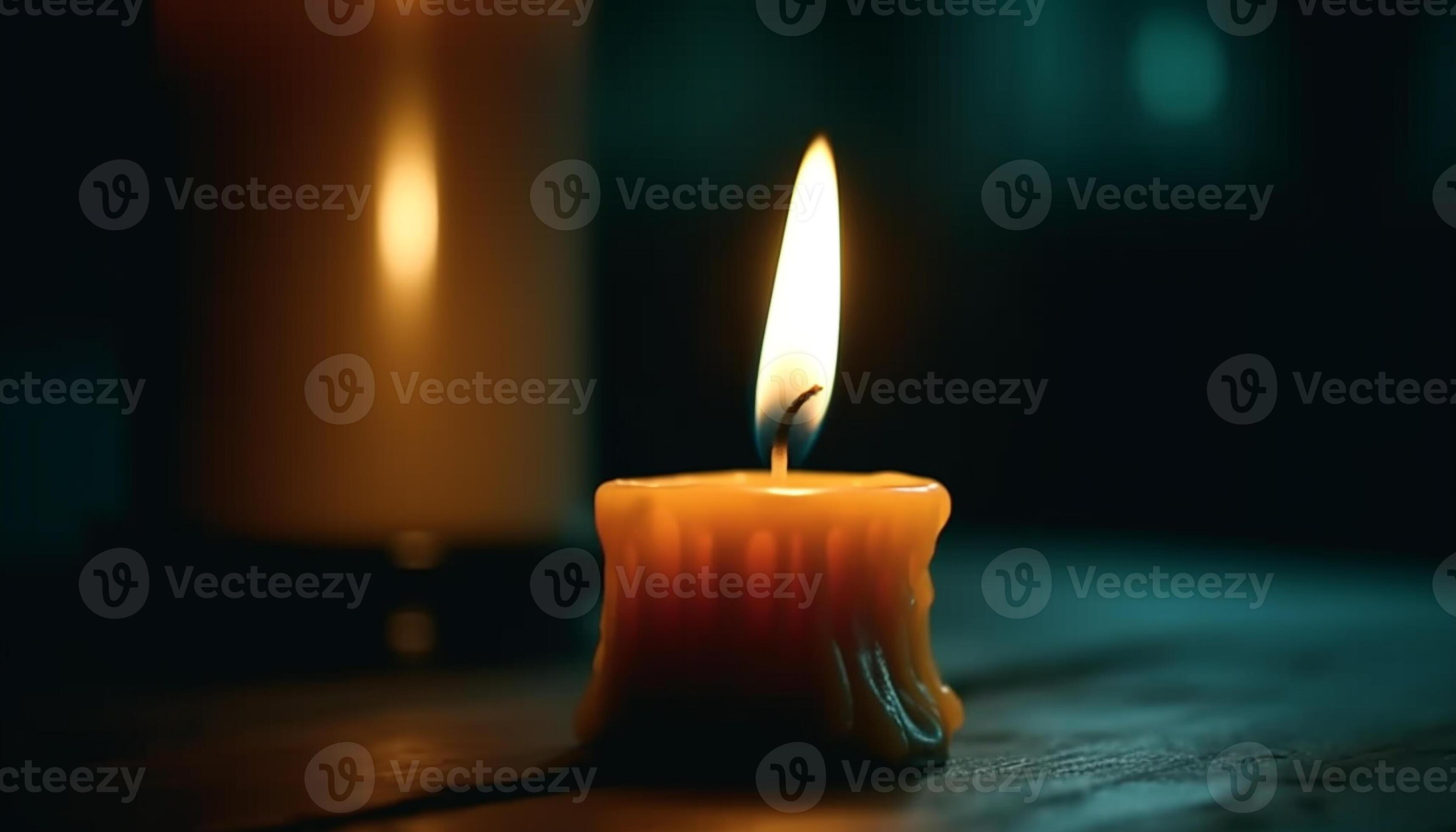 The glowing flame of the candle illuminates the dark night generated by
