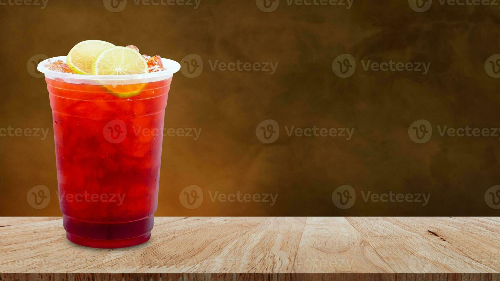 Premium Photo  Ice tea with slice of lemon in plastic cup on the wooden