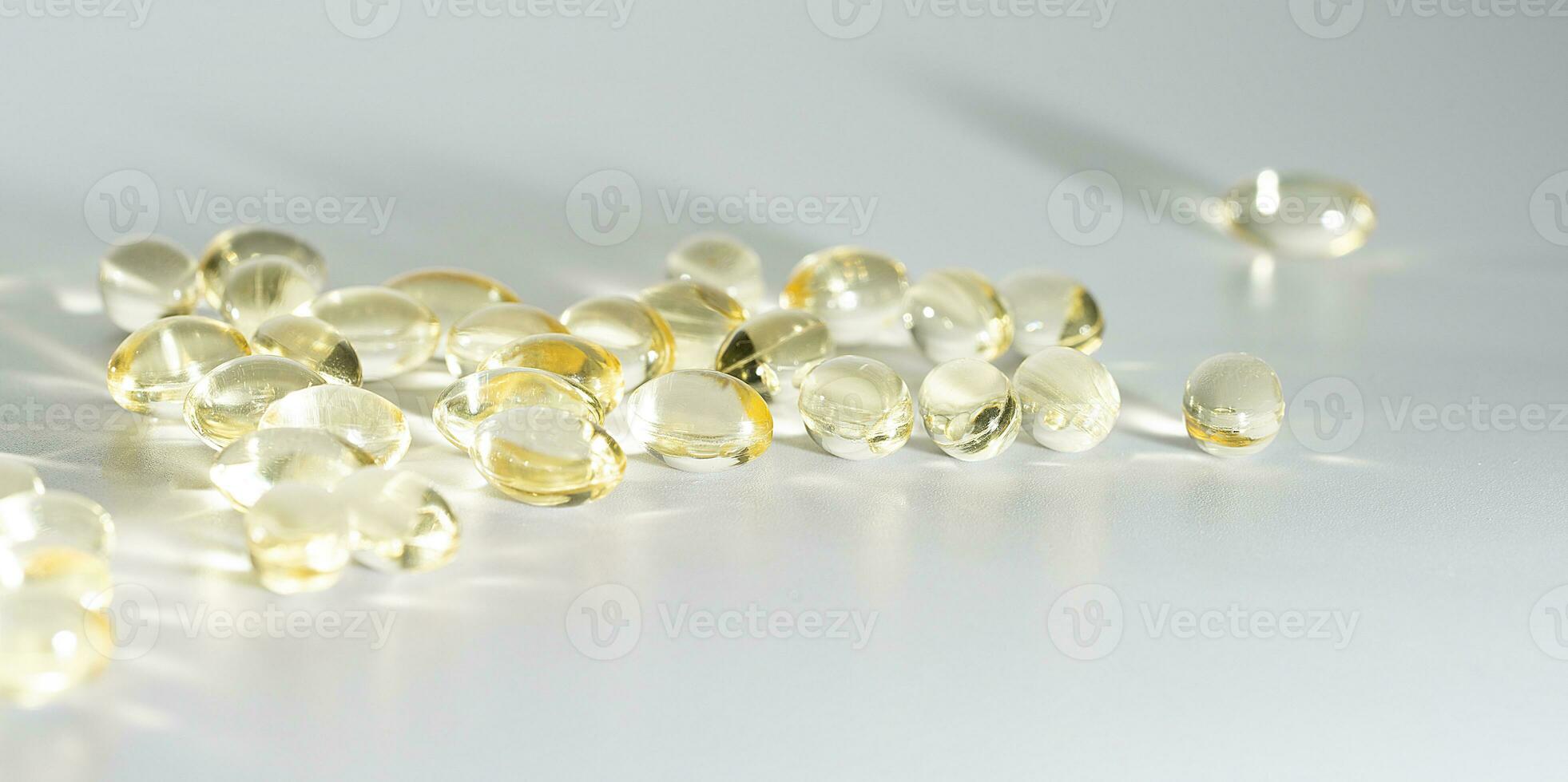 Fish Oil Omega 3 on white background, vitamin D yellow supplement gel capsules, macro shot photo