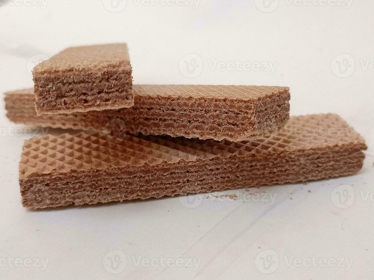 Delicious chocolate wafers on white background photo