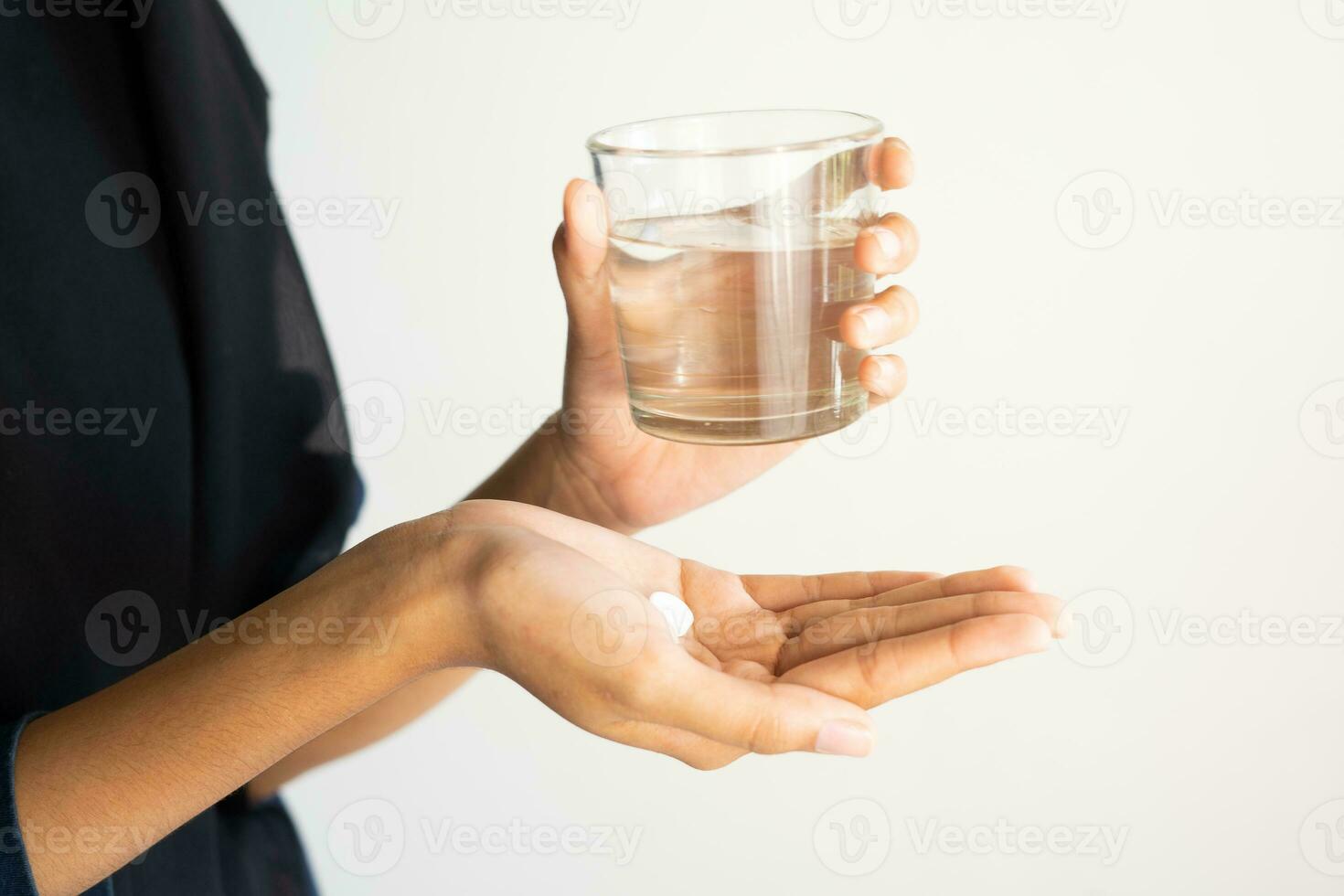 mano participación medicina y un vaso de Bebiendo agua. concepto de medicina y salud foto