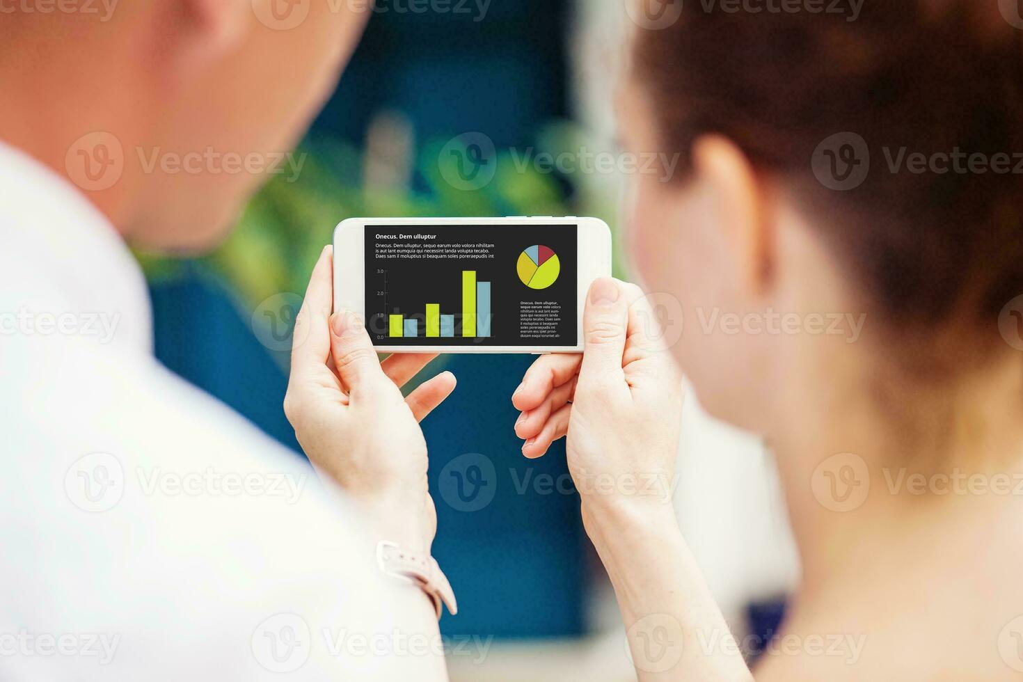 two people using a phone - blank screen app design mockup photo