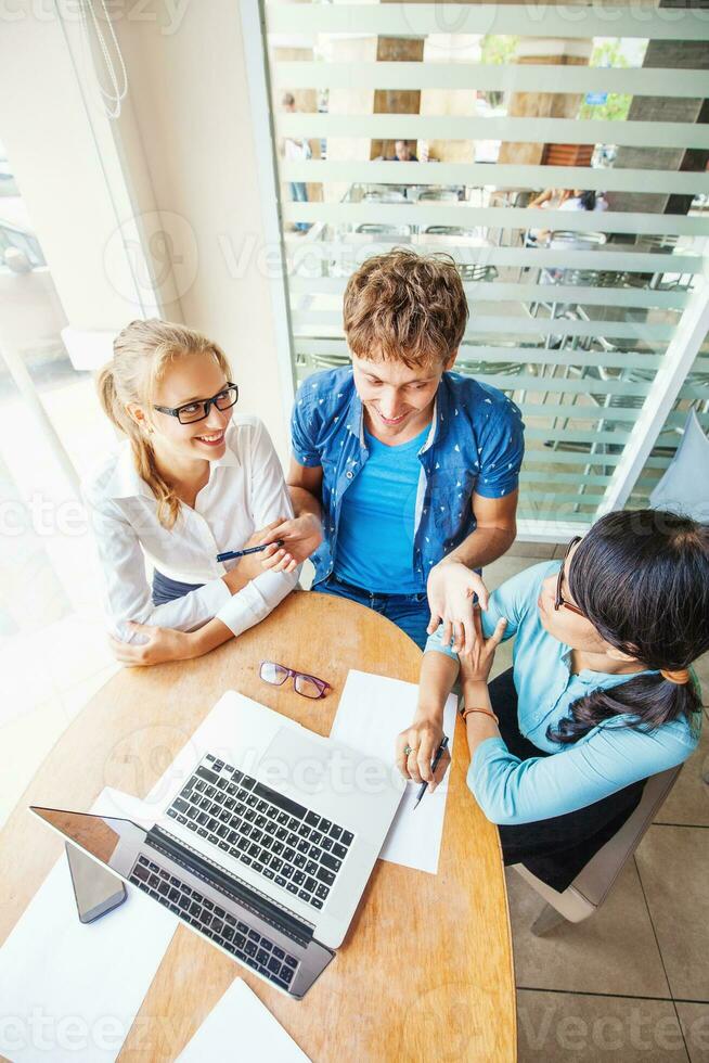 Multiracial company. Three people of different nationalities working together. The meeting photo