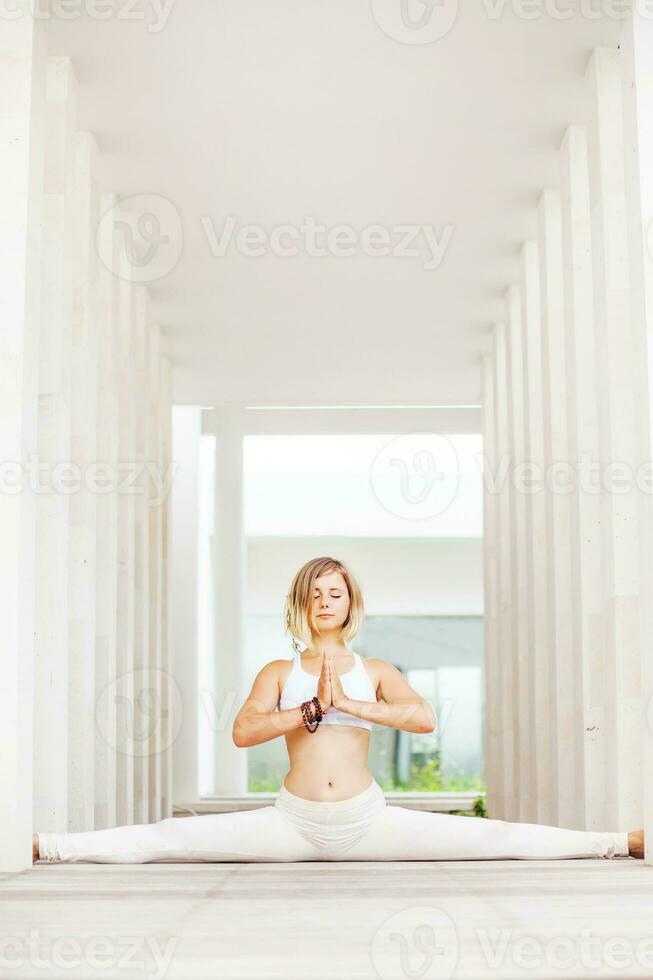 woman doing yoga asana anjaneyasana in a spacious studio photo