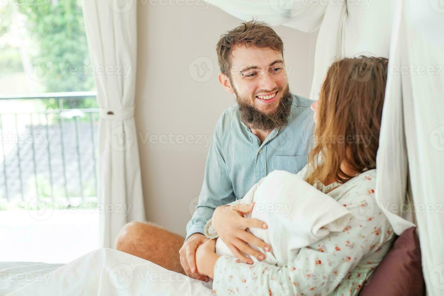 husband supports his wife after a childbirth photo