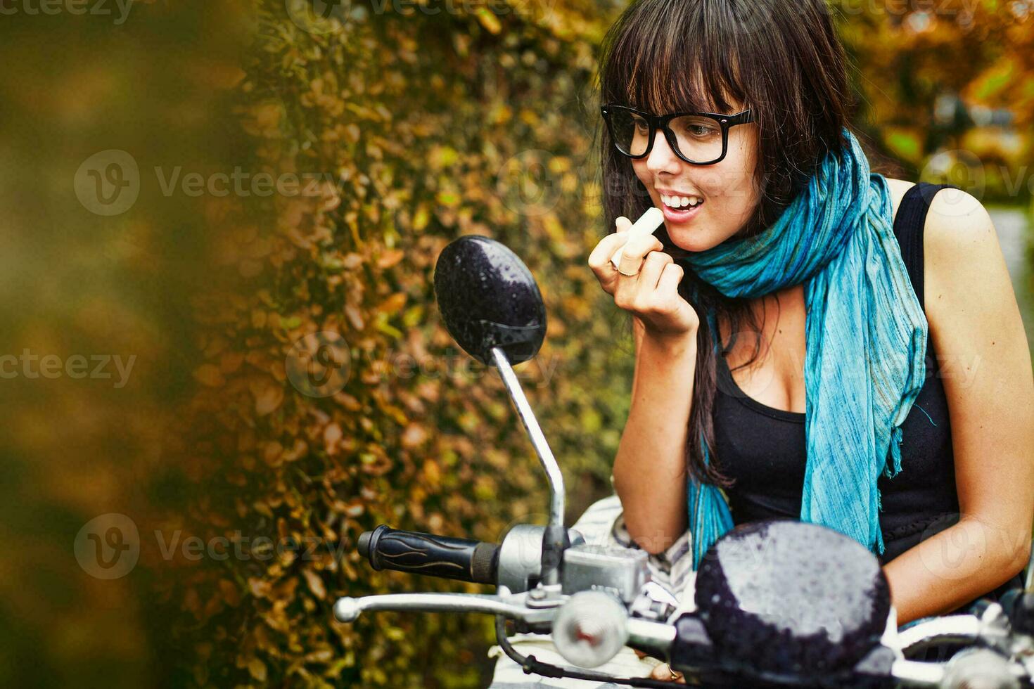 Stylish woman riding a motorbike photo
