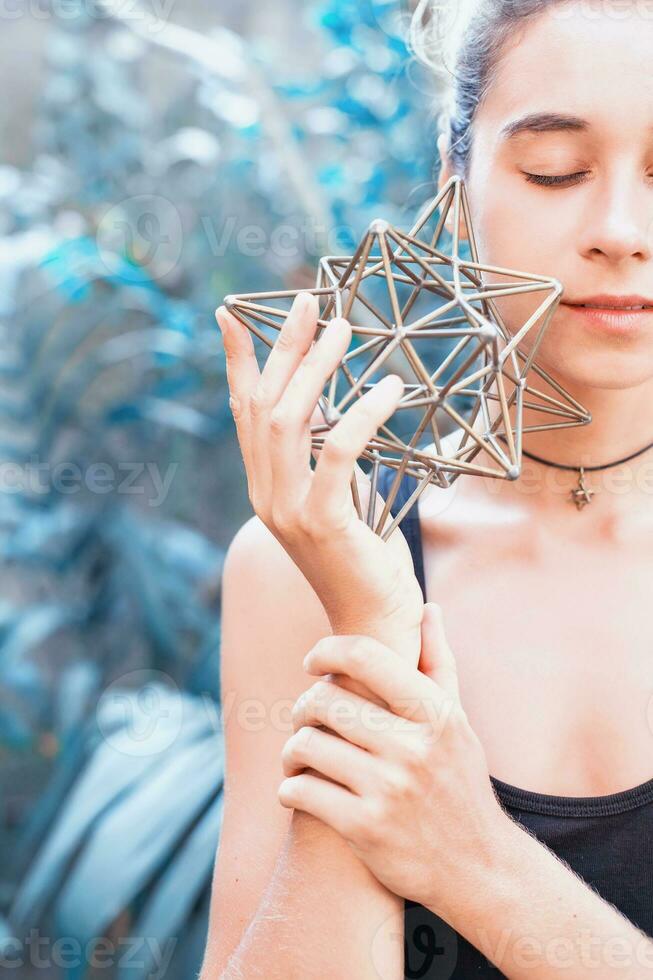 Woman meditating on sacred geometry photo