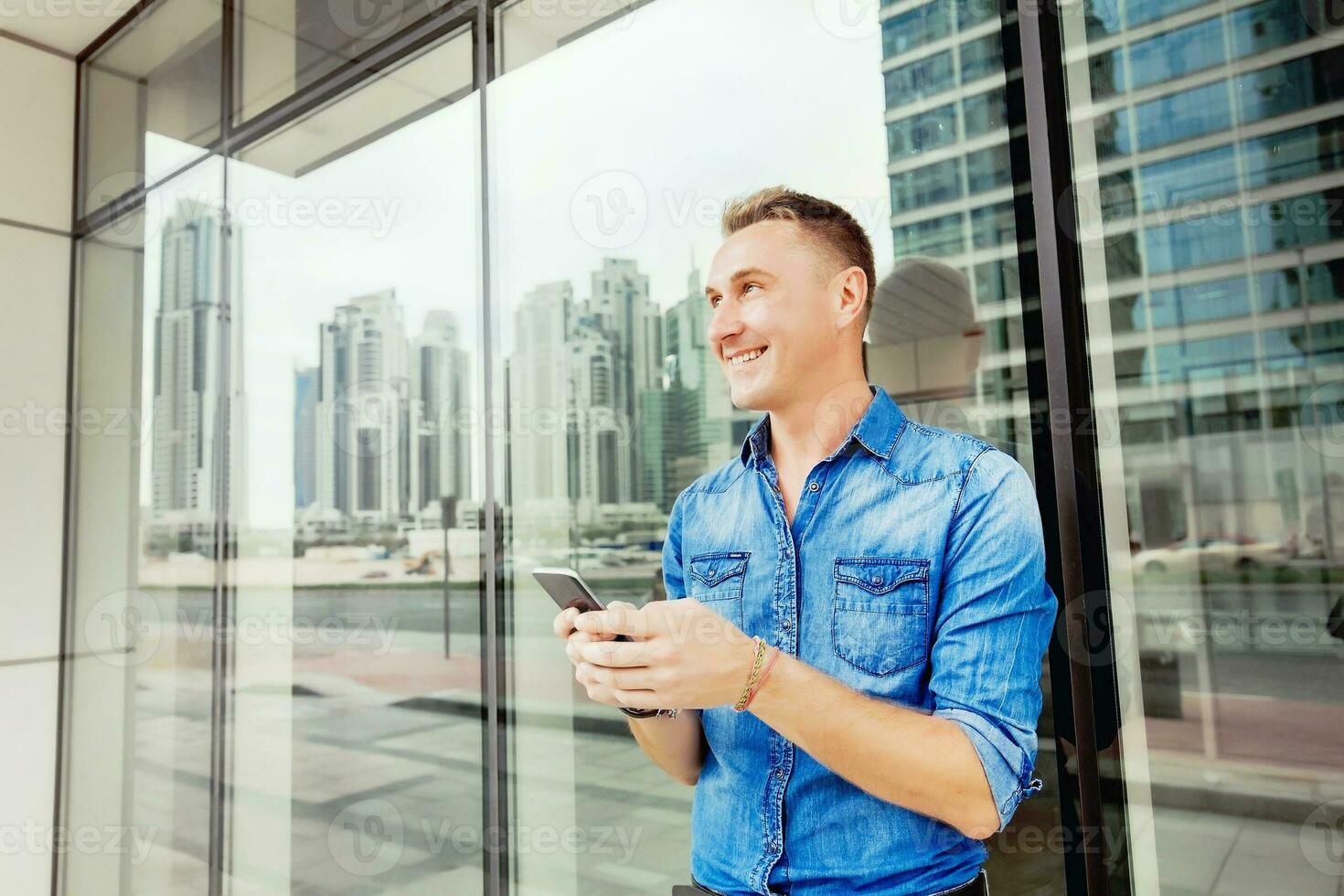man with smartphone in city photo