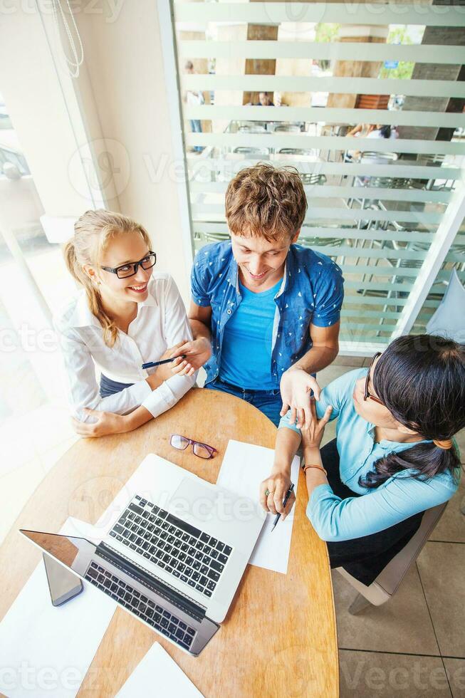 Multiracial company. Three people of different nationalities working together. The meeting photo